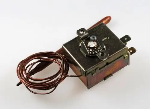 Temperaturwächter von Remko mit einer Kupferwicklung und einem metallischen Gehäuse, ausgestattet mit Anschlüssen für die elektrische Verbindung.