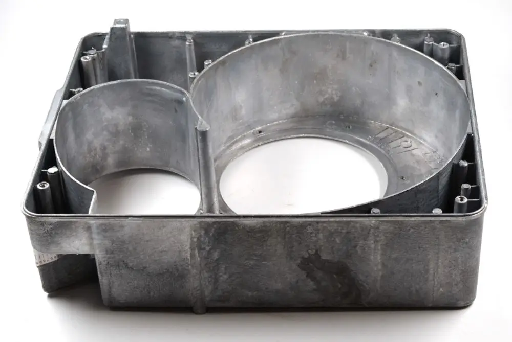 Brennergehäuse von Remko mit mehreren Öffnungen und einer Lufteinstellschraube, aus Metall gefertigt und in rechteckiger Form.