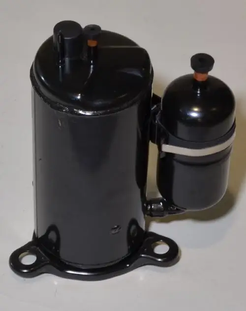 Schwarzer Kompressor mit zwei angeschlossenen Ventilen, hergestellt von Remko. Das Design zeigt eine zylindrische Form und eine Montagebasis mit Löchern.
