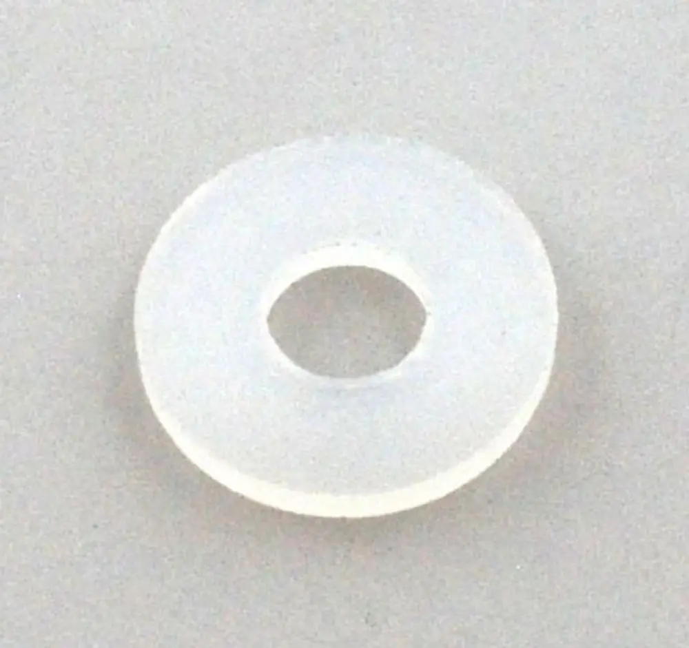 Durchsichtige Dichtung aus Nylon mit mittigem Loch, geeignet für Verwendung in Verbindungselementen von Remko Produkten. Flache, runde Form ohne erkennbare Maße.
