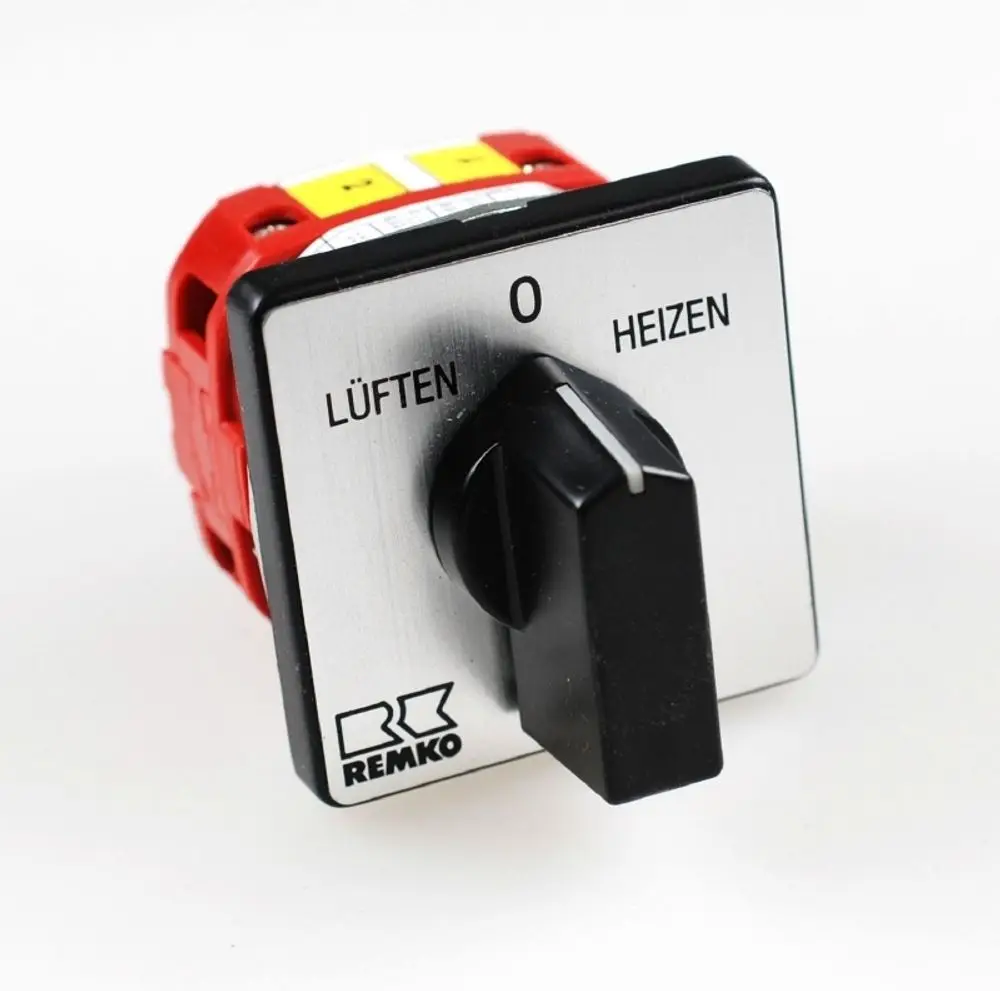 Betriebsschalter von Remko mit zwei Funktionen: Heizen und Lüften. Der Schalter hat eine schwarze Drehknopfoberfläche und eine silberne Blende mit Beschriftung.