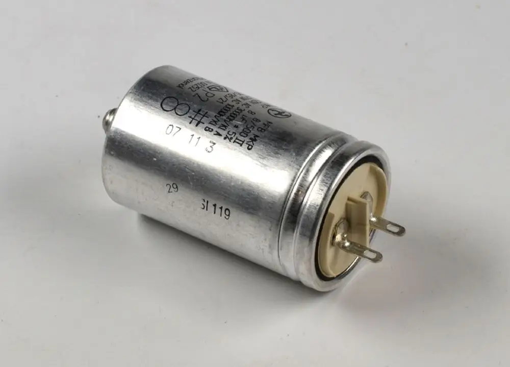 Metallischer Kondensator von Remko mit zwei Anschlussstiften. Die Oberfläche ist silbern und die Beschriftung ist teilweise sichtbar.