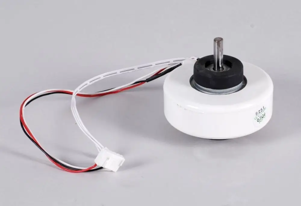 Remko Ventilatormotor mit drei Drähten, einem Metallachsenansatz und einer runden Gehäuseform in Weiß. An der Oberseite befindet sich ein gummierter Ring.