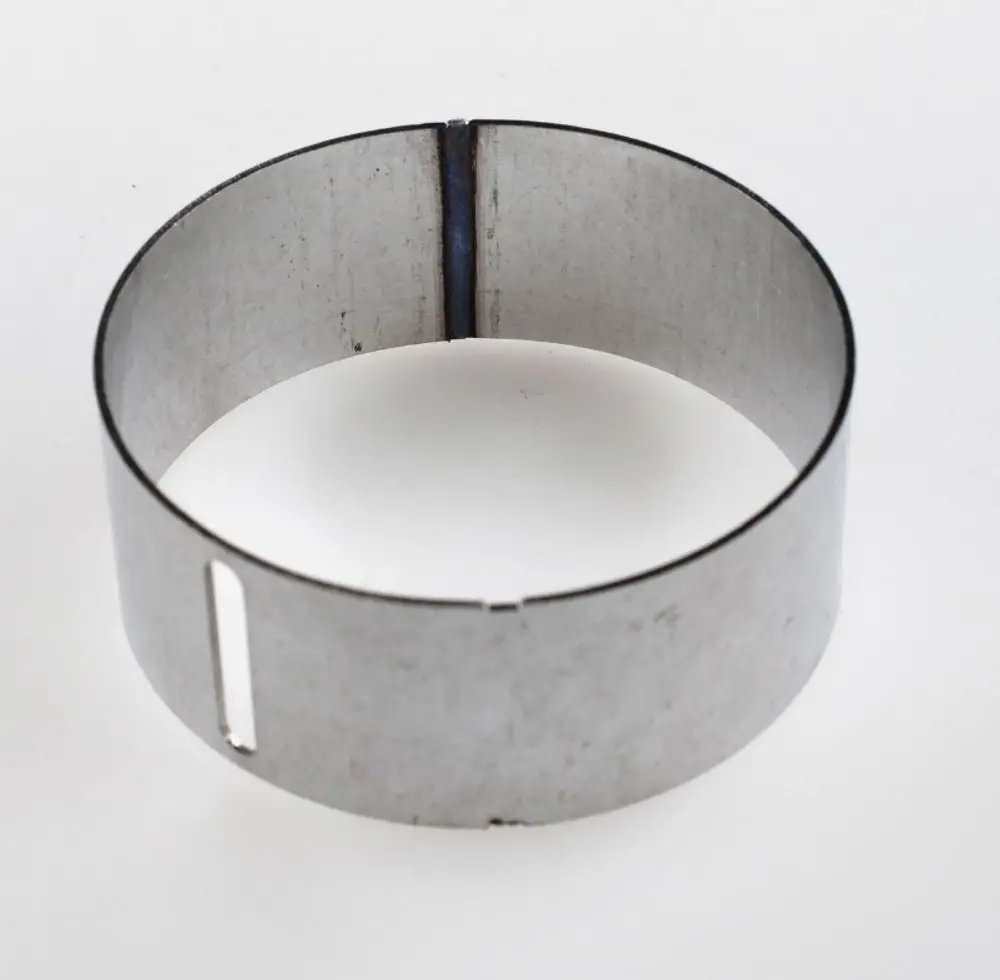 Zylindrischer Metallring von Remko, offen in der Mitte, mit einer schmalen Schlitzöffnung. Eignet sich für verschiedene Anwendungen in der Metallverarbeitung.