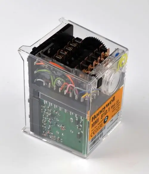 Transparente Steuerbox mit elektrischen Komponenten und bunten Drähten, die von der Marke Remko stammt. Circuit Boards und Zahnräder sichtbar.