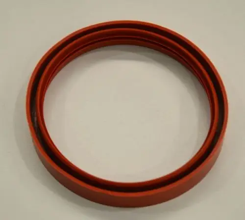 Dichtring in roter Farbe, flach und zylindrisch, präsentiert auf einer hellen Oberfläche. Er kann in Anwendungen von Remko verwendet werden.