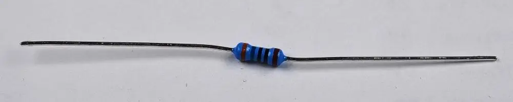 Widerstand mit Farbkennzeichnung in Blau und Schwarz, montiert auf zwei Drahtanschlüssen. Hersteller ist Remko.