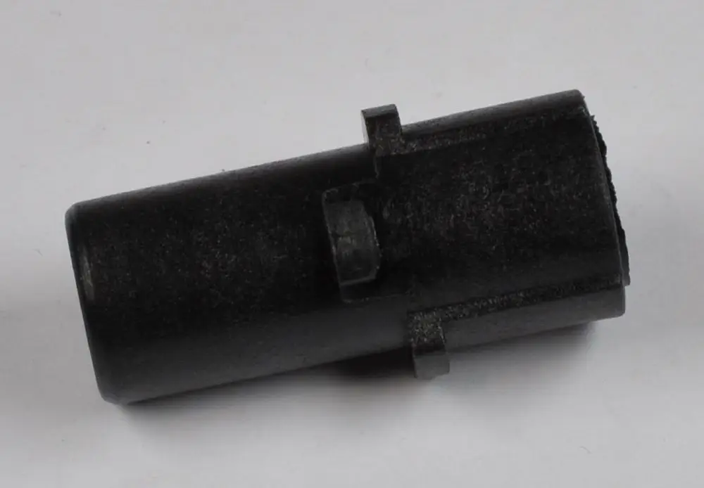 Schwarzer Kunststoffteil mit zylindrischer Form und seitlichem Halteclip. Teil gehört zu einer Fotozelle der Marke Remko.