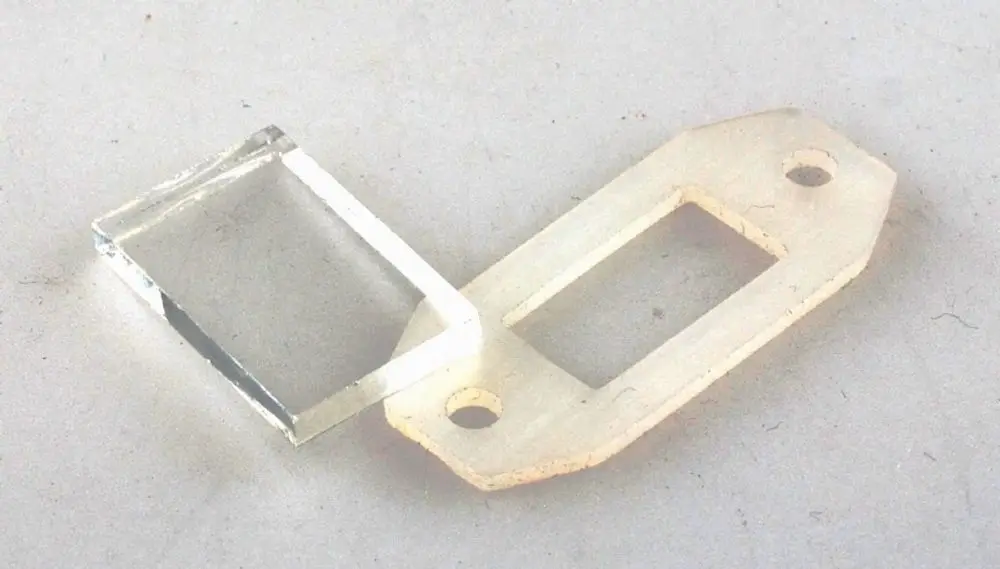 Schauglas von Remko, aus klarem Material, mit Dichtung. Es zeigt eine rechteckige Form und hat zwei Bohrungen zur Montage.