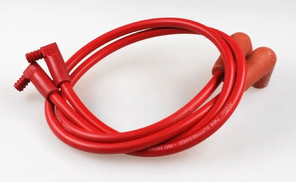 Rote Zündkabel mit Steckern, die gut in einer Werkstatt oder für Reparaturarbeiten verwendet werden können. Produkt von Remko, erkennbar an den typischen Steckerformen.