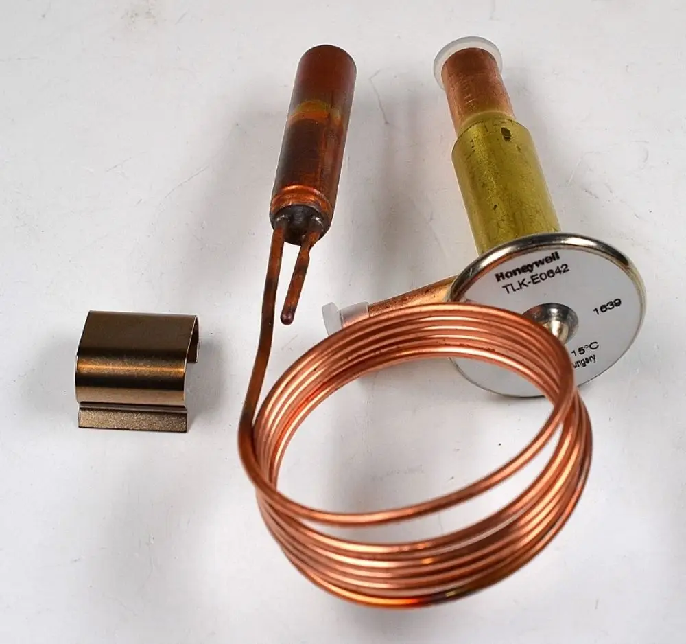Thermoventil mit Kupferrohr und Metallanschlüssen, hergestellt von Remko. Komponenten umfassen einen Zylinder und eine Drahtspule für Temperaturregelung.