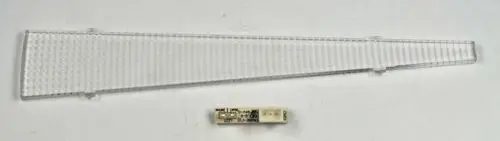 Transparente LED-Beleuchtungskomponente der Marke Remko mit schmaler, dreieckiger Form und einer elektronischen Platine in der Mitte.