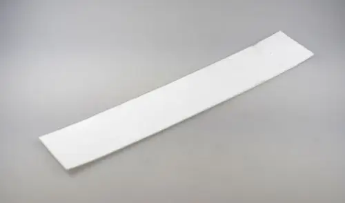 Weiße Dichtung für eine Reinigungsöffnung, flach und länglich, aus einem leichten Material. Geeignet für Anwendung in Geräten der Marke Remko.