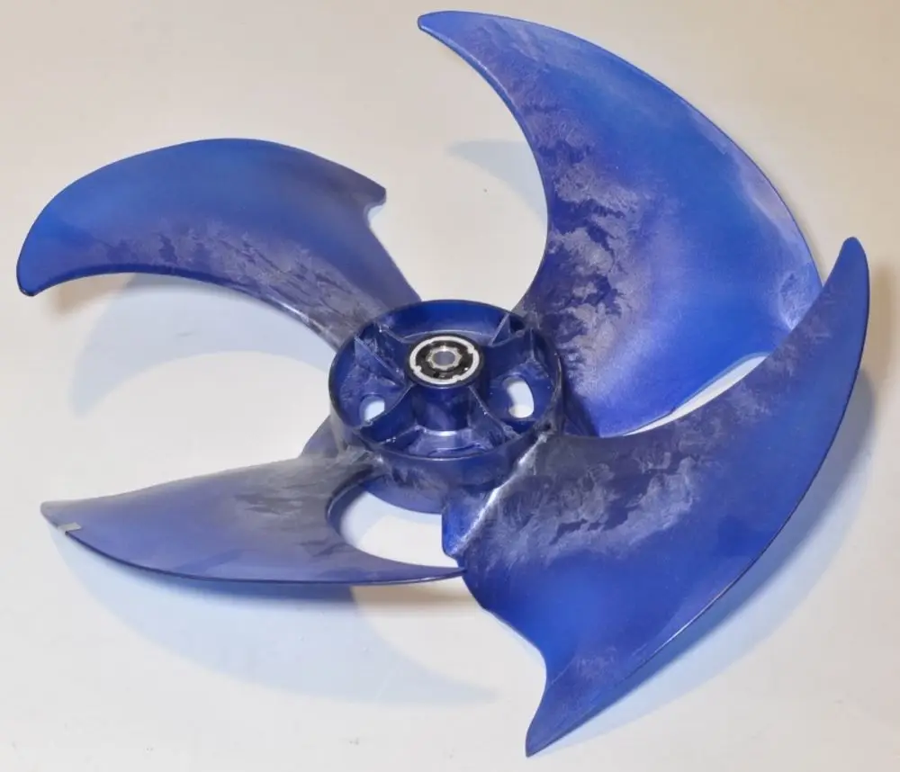 Blauer Ventilatorflügel mit vier geschwungenen Blättern, montiert auf einer zentralen Achse, verwendet in einem Remko-Verflüssiger.