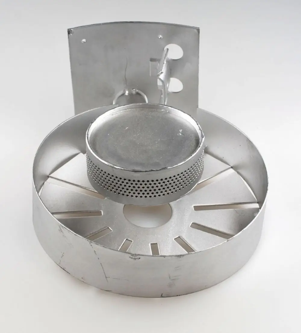 Gasbrenner von Remko, bestehend aus runden und flachen Metallteilen mit Belüftungsöffnungen, gestaltet für die Befestigung und Einsatz in Heizsystemen.