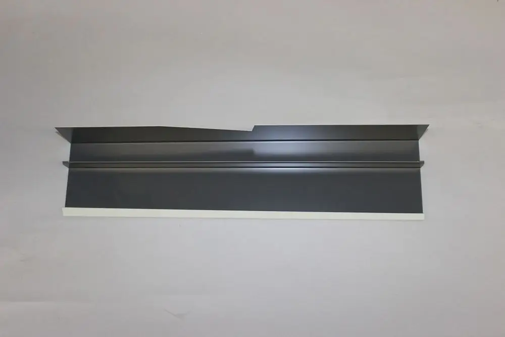 Seitenwand in dunklem Metall, wahrscheinlich für ein Brötje-Gerät, flach und ohne erkennbare Maße, auf grauem Hintergrund.