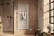 Kermi Credo Half round Elektroheizkörper im Badezimmer an Backsteinwand mit Handtuch